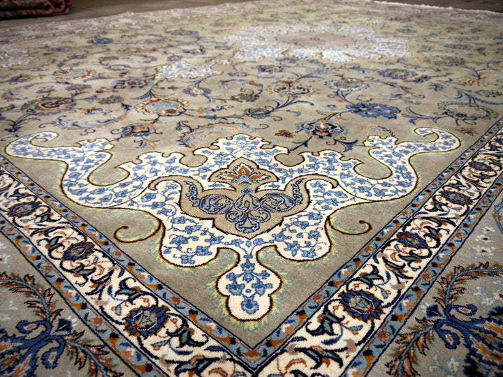 Kashan rug central floral medallion in light blue and ivory on a sage-green ground, oblique view — 12102