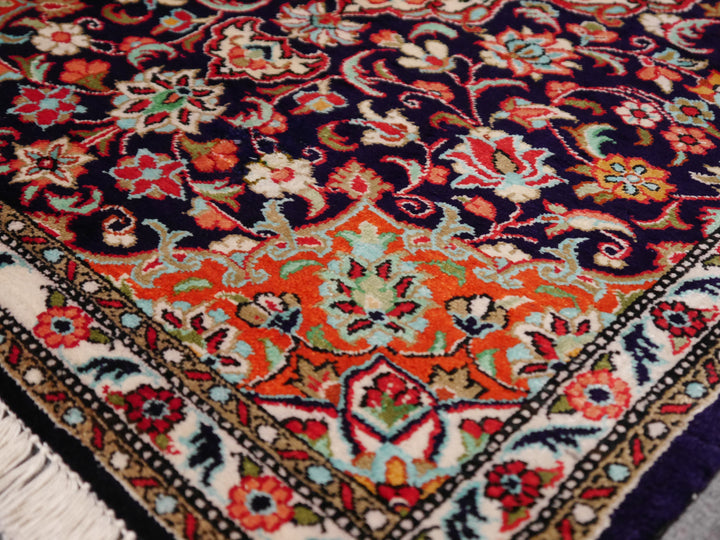 Close-up of ultra-fine 1,000,000 knots per sqm weave of a Ghom silk rug, showing intricate floral details. 3