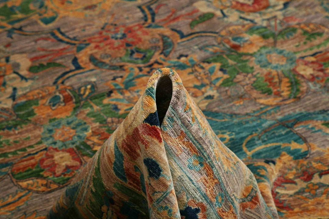 This beautiful rug originated in rural Afghanistan, where it was hand-knotted by tribal weavers. The pile material is handspun wool that has been dyed with vegetable and mineral pigments. The motifs are made of silver-colored bamboo silk. It is of excellent quality with a subtle sheen and elegant organic colors. The design comes from ancient Persia. The style of this rug is known as a polonaise pattern and is typical of antique rugs from the Safavid Dynasty in the late 16th century. 