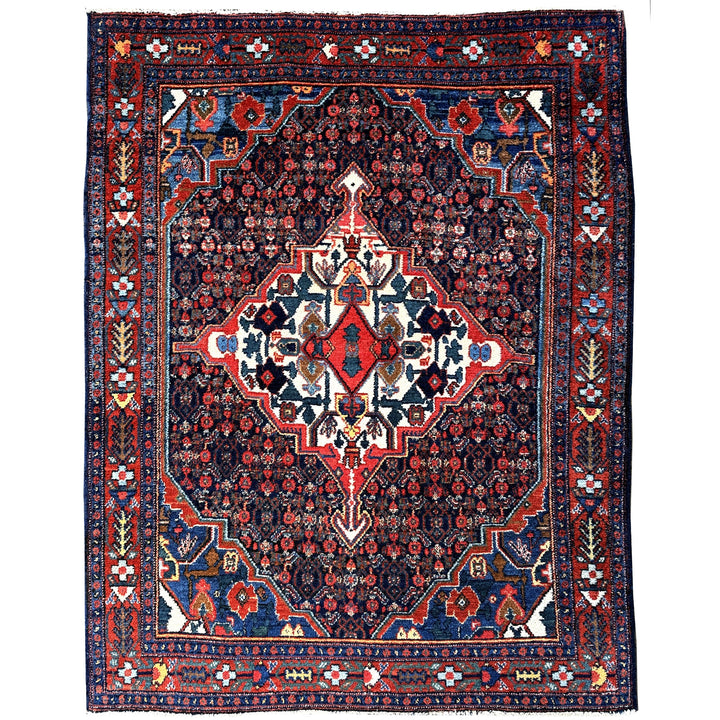 A hand - knotted antique Persian Senneh Sanandaj rug with a blue field, red border and ivory medaillon. Very good overall condition, equally even pile, fringes newly secured and original shirazi. Beautiful collectors piece, kurdish traditional carpet.