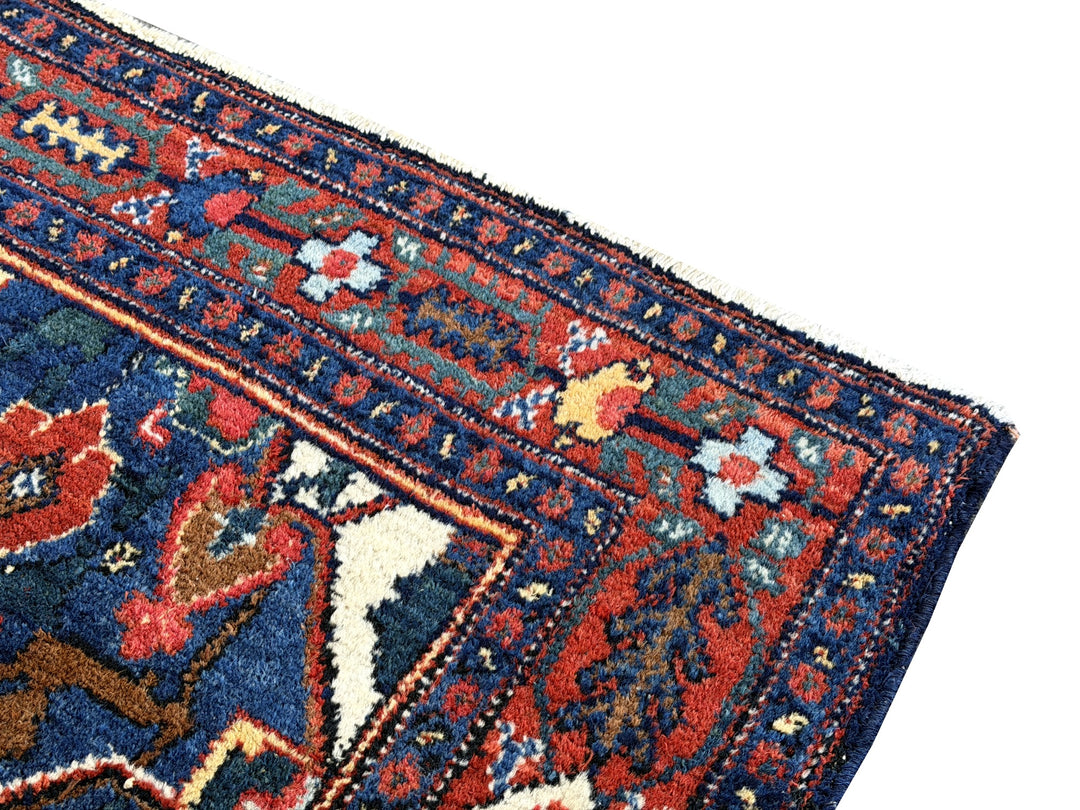 A hand - knotted antique Persian Senneh Sanandaj rug with a blue field, red border and ivory medaillon. Very good overall condition, equally even pile, fringes newly secured and original shirazi. Beautiful collectors piece, kurdish traditional carpet.