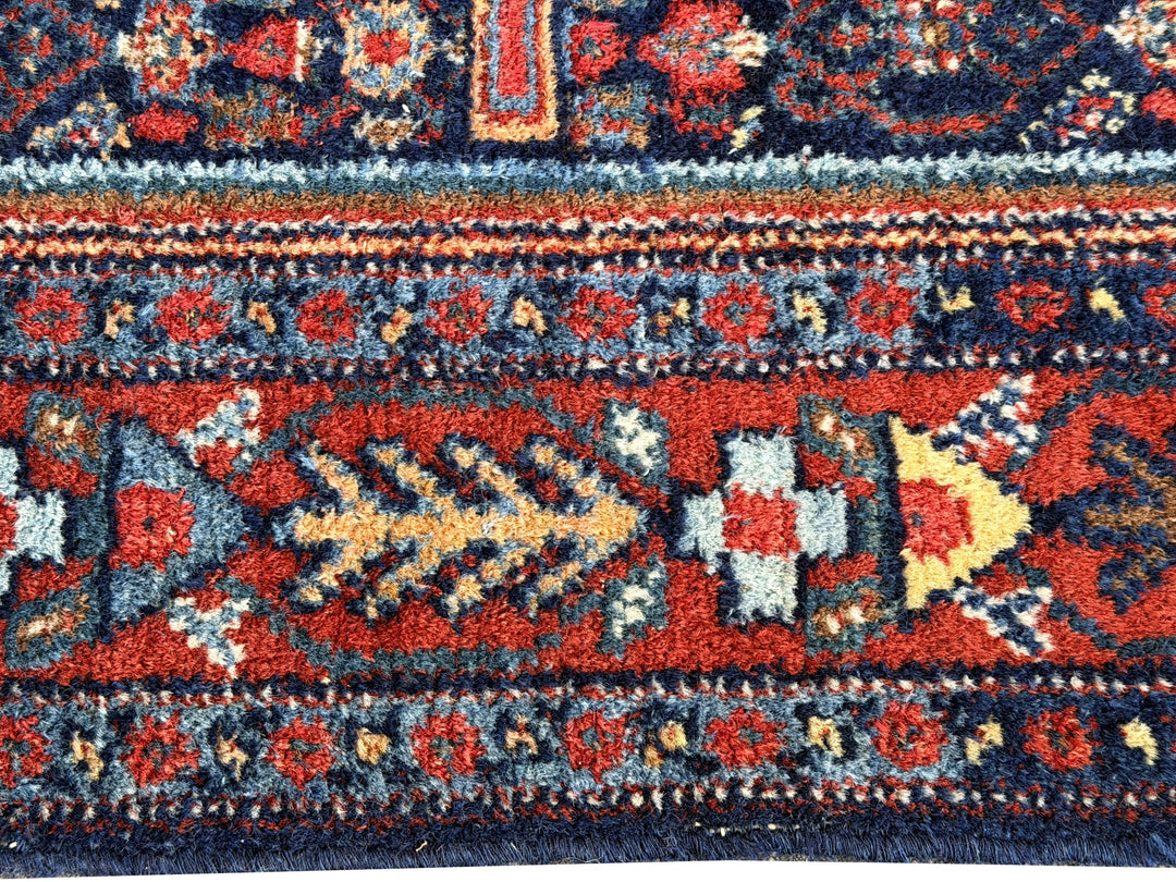A hand - knotted antique Persian Senneh Sanandaj rug with a blue field, red border and ivory medaillon. Very good overall condition, equally even pile, fringes newly secured and original shirazi. Beautiful collectors piece, kurdish traditional carpet.