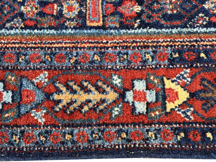 A hand - knotted antique Persian Senneh Sanandaj rug with a blue field, red border and ivory medaillon. Very good overall condition, equally even pile, fringes newly secured and original shirazi. Beautiful collectors piece, kurdish traditional carpet.