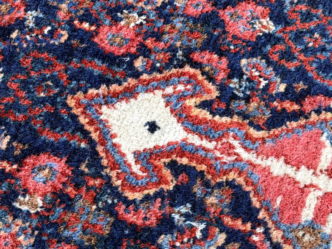A hand - knotted antique Persian Senneh Sanandaj rug with a blue field, red border and ivory medaillon. Very good overall condition, equally even pile, fringes newly secured and original shirazi. Beautiful collectors piece, kurdish traditional carpet.