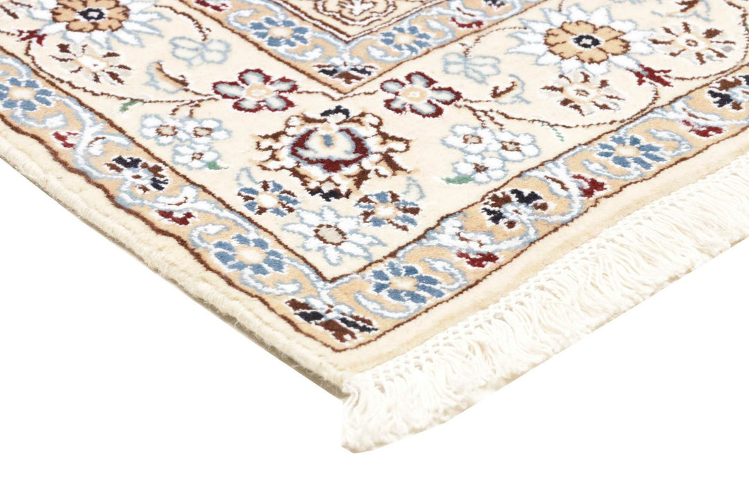 This fine, Persian rug is a typical piece in the popular traditional Nain design. The colors are a wool white field, beige border and light blue accents. The size is 203 x 132 cm, the quality is 9la. The round Medaillon is floral like the field and corners.