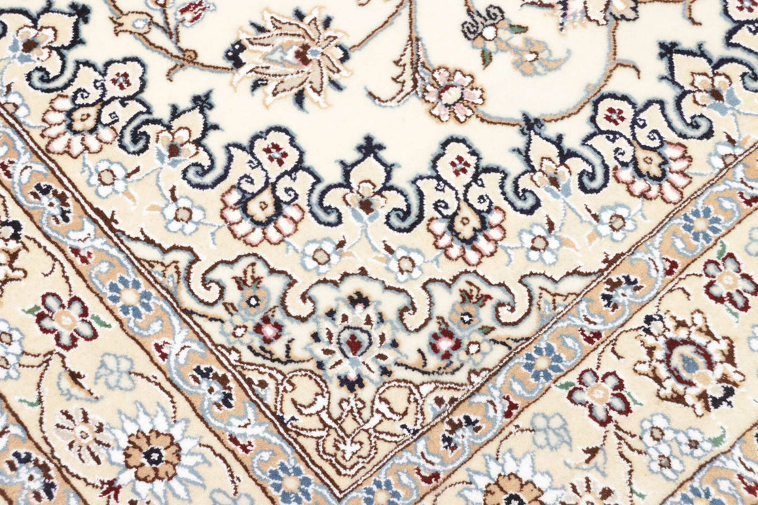 This fine, Persian rug is a typical piece in the popular traditional Nain design. The colors are a wool white field, beige border and light blue accents. The size is 203 x 132 cm, the quality is 9la. The round Medaillon is floral like the field and corners.