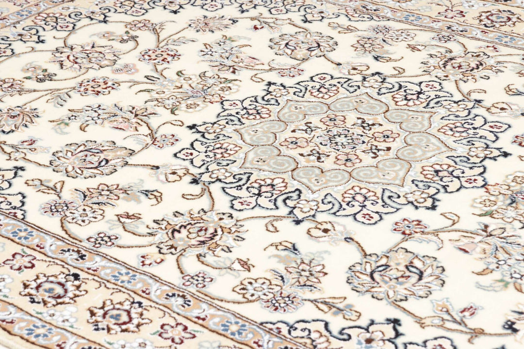 This fine, Persian rug is a typical piece in the popular traditional Nain design. The colors are a wool white field, beige border and light blue accents. The size is 203 x 132 cm, the quality is 9la. The round Medaillon is floral like the field and corners.