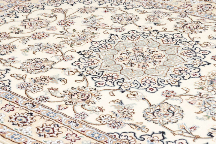 This fine, Persian rug is a typical piece in the popular traditional Nain design. The colors are a wool white field, beige border and light blue accents. The size is 203 x 132 cm, the quality is 9la. The round Medaillon is floral like the field and corners.