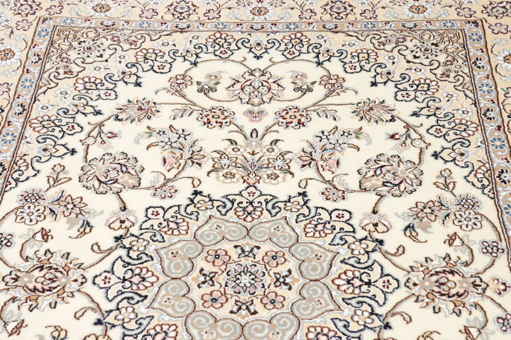 This fine, Persian rug is a typical piece in the popular traditional Nain design. The colors are a wool white field, beige border and light blue accents. The size is 203 x 132 cm, the quality is 9la. The round Medaillon is floral like the field and corners.