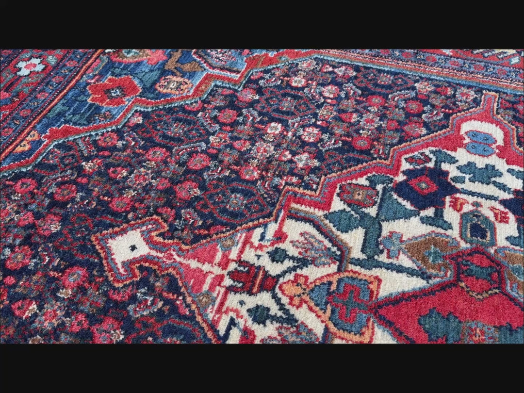A hand - knotted antique Persian Senneh Sanandaj rug with a blue field, red border and ivory medaillon. Very good overall condition, equally even pile, fringes newly secured and original shirazi. Beautiful collectors piece, kurdish traditional carpet.